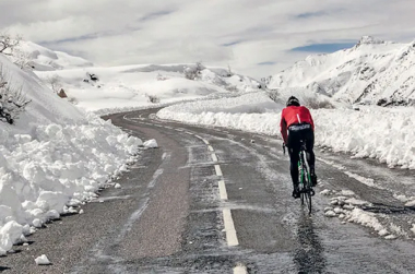 keith tuffley cycling on a snow lined road